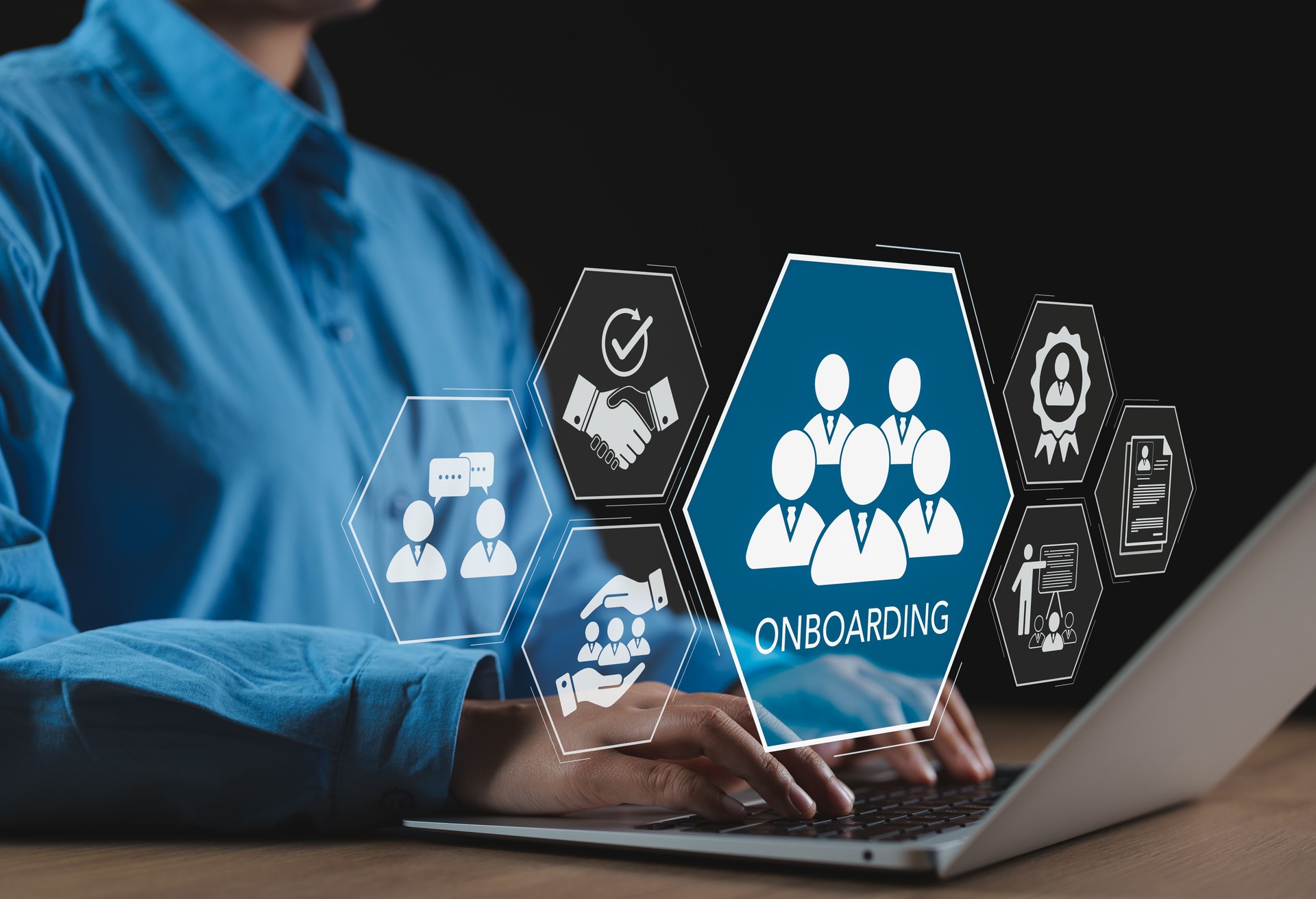 Onboarding Process for New Employees. Businesspeople use laptop with onboarding icons, symbolizing employee integration, orientation, HR management, recruitment, communication, and training workplace.